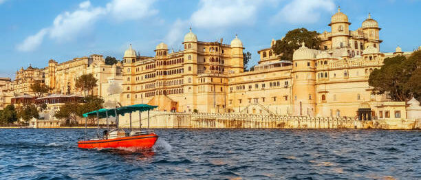 City Palace Udaipur Rajasthan India as seen from a boat on lake Pichola